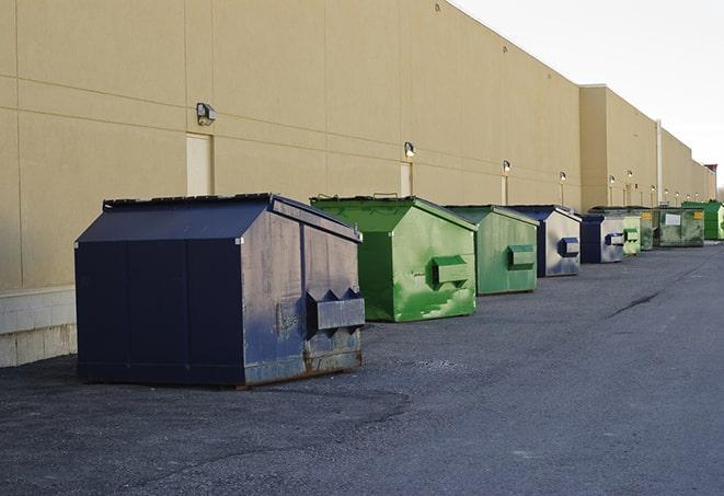 a row of blue construction dumpsters on a job site in Deerfield MI